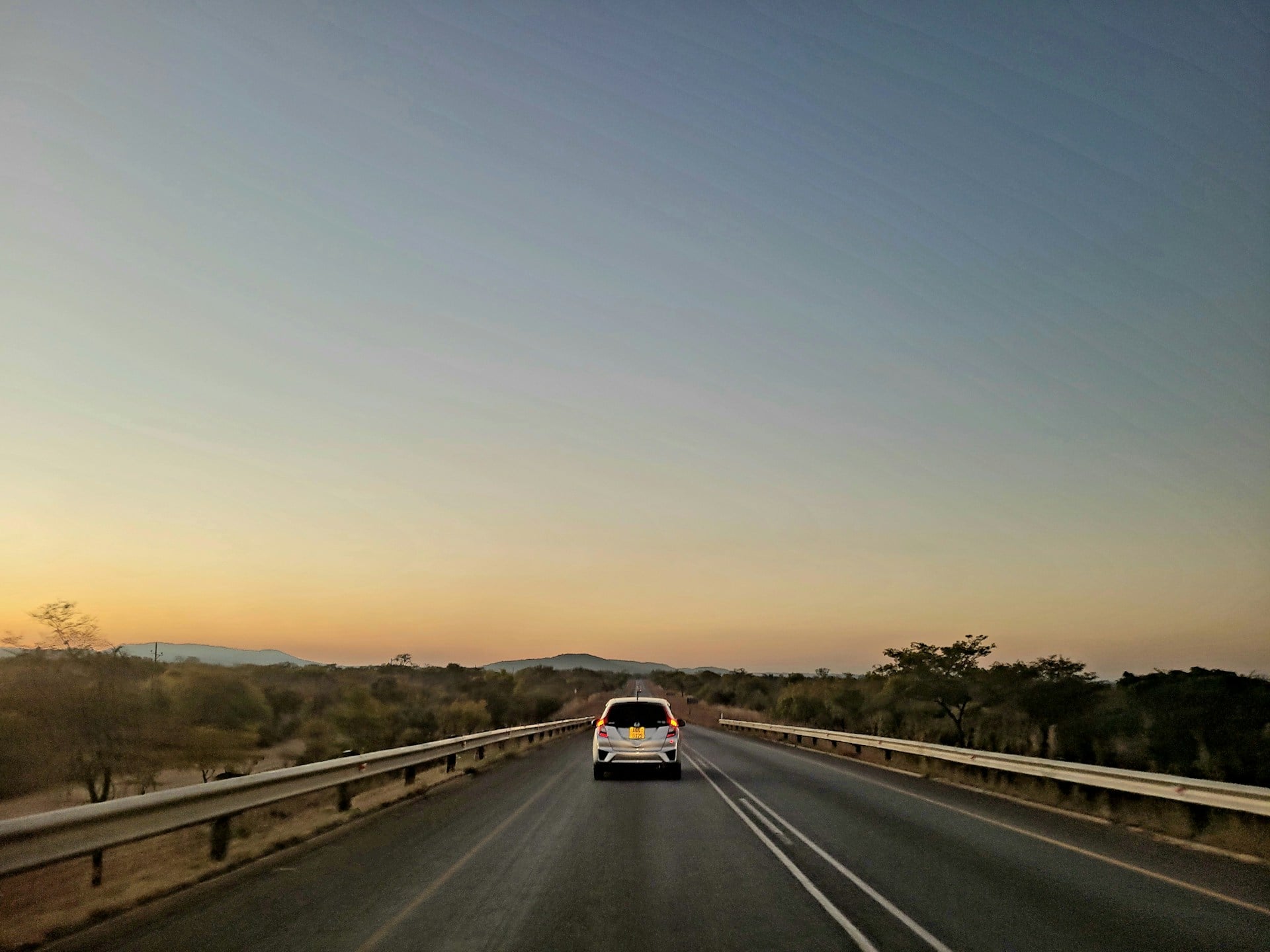 Car on an open highway at dusk