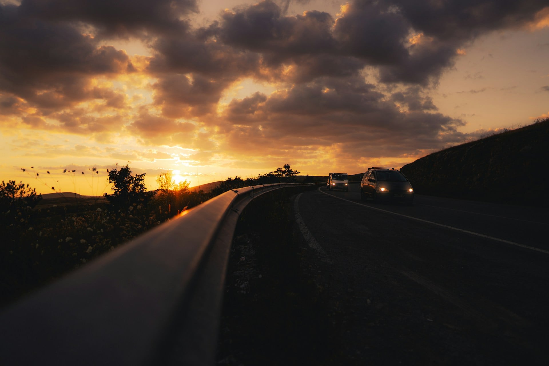 Car driving on a scenic road at sunset